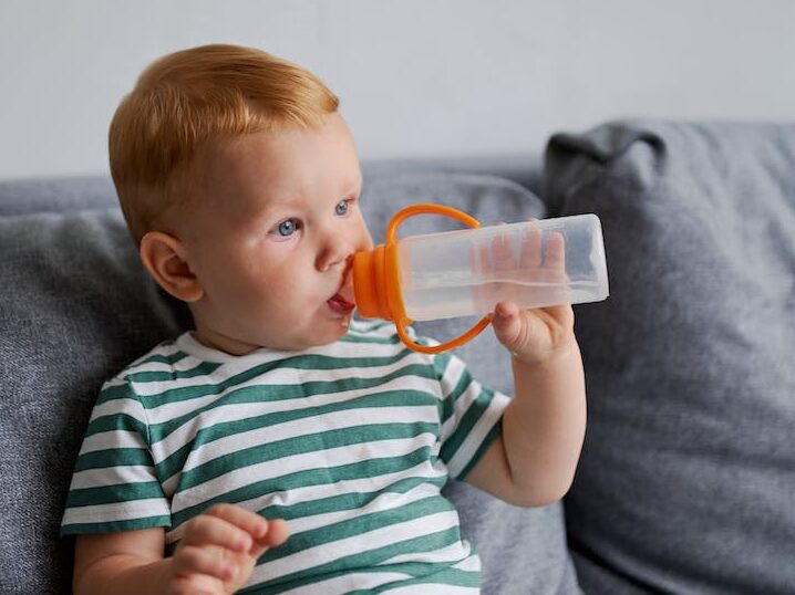 little boy drinking water from bottle